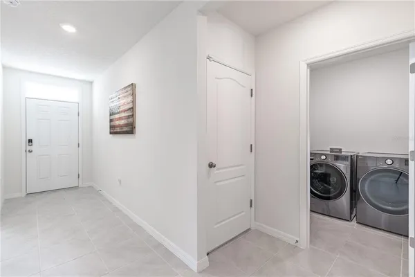 a view of a storage & utility room with a washer dryer