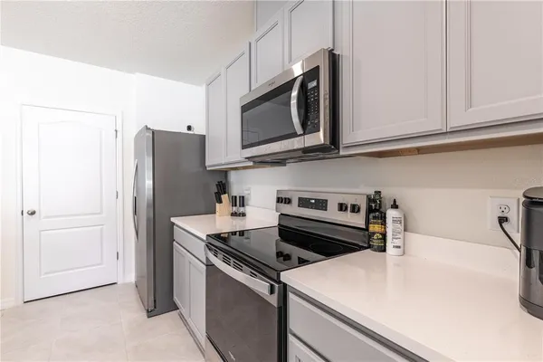 a kitchen with stainless steel appliances a refrigerator stove and microwave