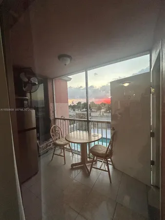 a balcony with chairs and a table