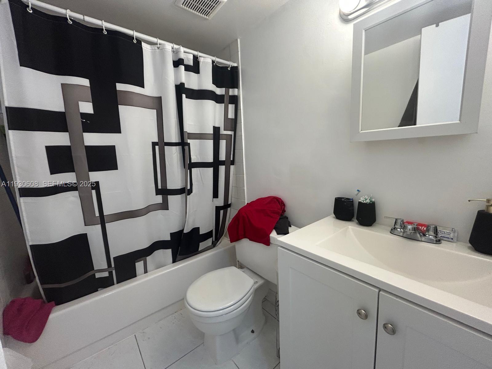 19771 Southwest 114th Avenue, Unit 329 Miami, FL 33157 - Photo 8 of 12 a bathroom with a sink a toilet and shower