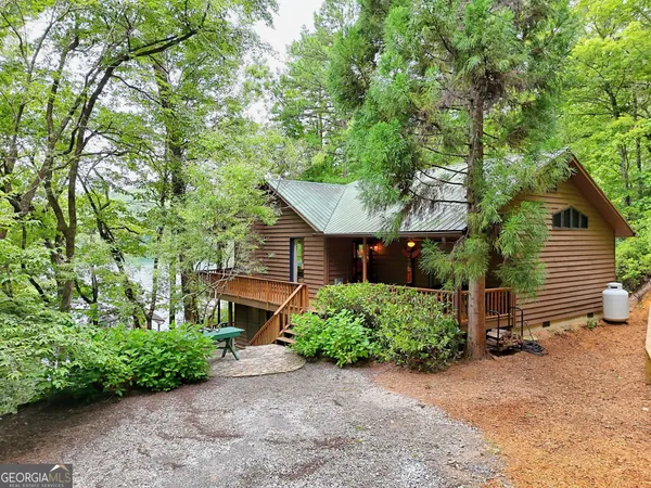 a view of a house with a yard and sitting area