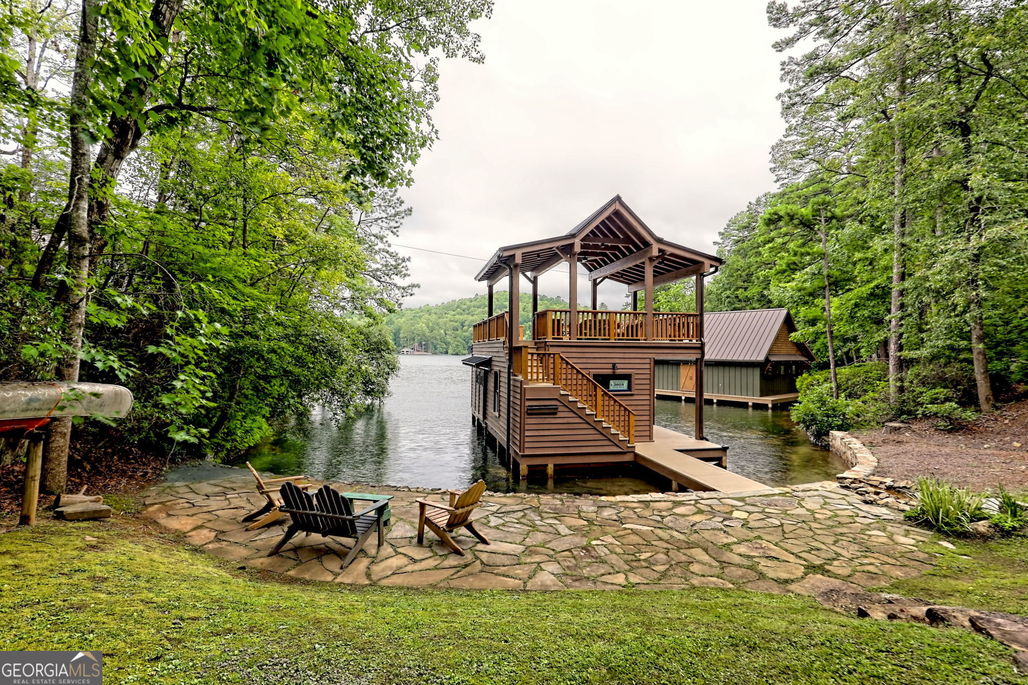 3019 Moccasin Creek Road Clarkesville, GA 30523 - Photo 56 of 72 a view of a house with a yard chairs and table in the patio