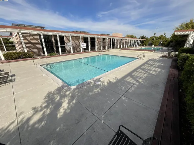 a view of a house with pool and sitting area