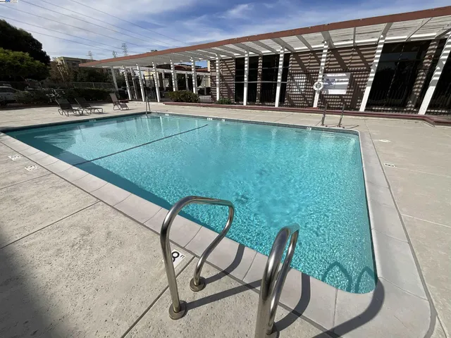 a view of a swimming pool with a lounge chair