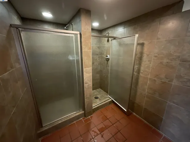 a bathroom with a glass door shower