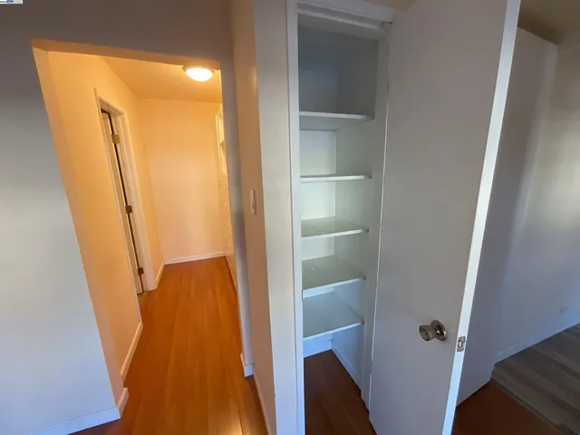 a view of walk in closet with empty racks