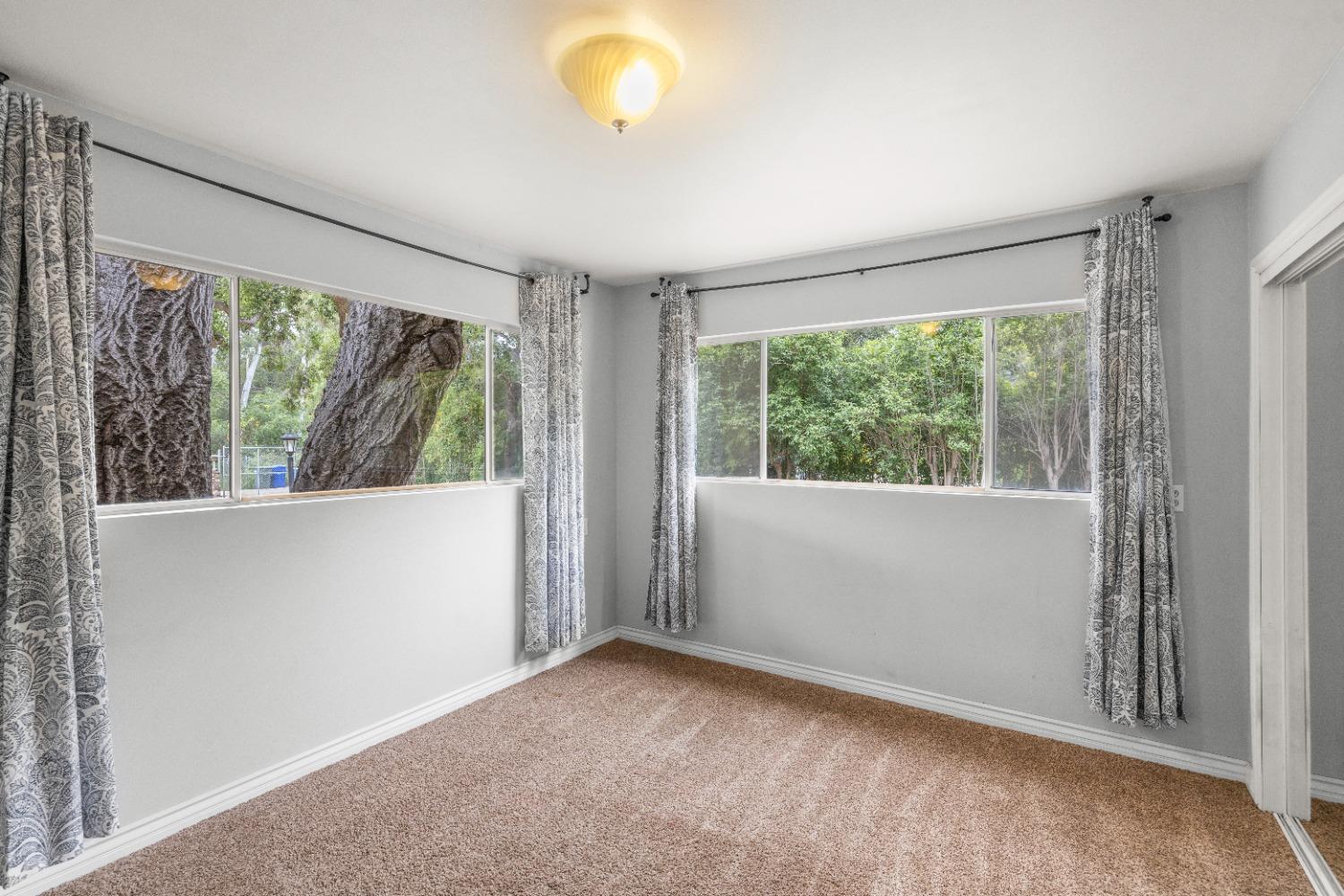 272 Rockaway Road Oak View, CA 93022 - Photo 26 of 33 an empty room with wooden floor and windows