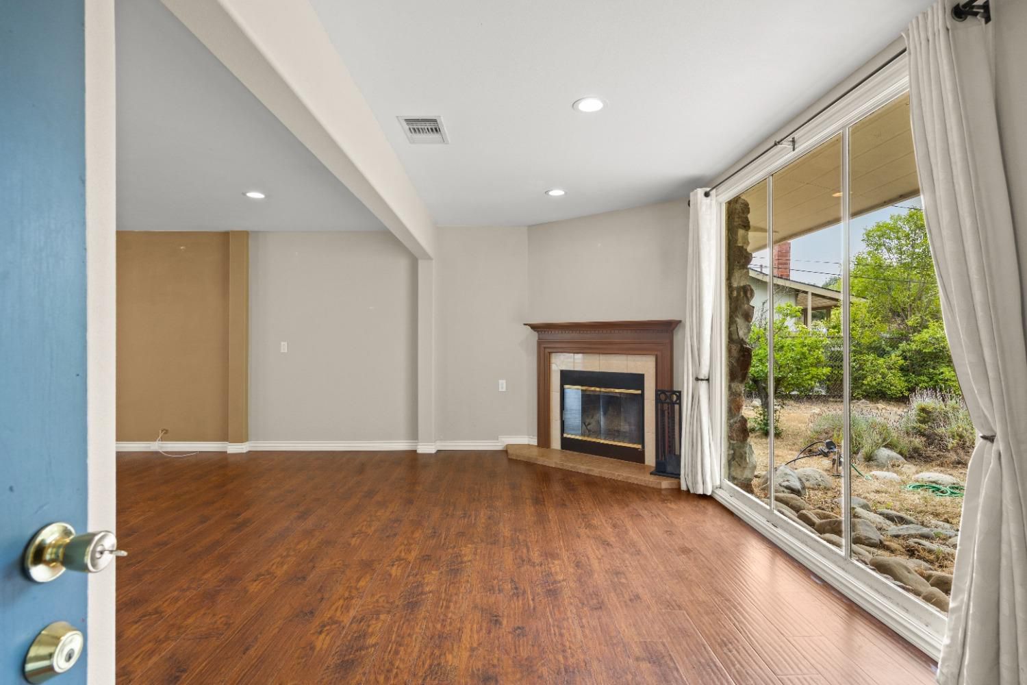272 Rockaway Road Oak View, CA 93022 - Photo 5 of 33 a view of an empty room with a fireplace and a window