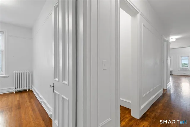 a view of a hallway with wooden floor