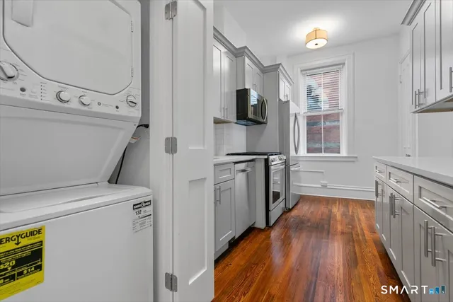 a kitchen with cabinets and wooden floor