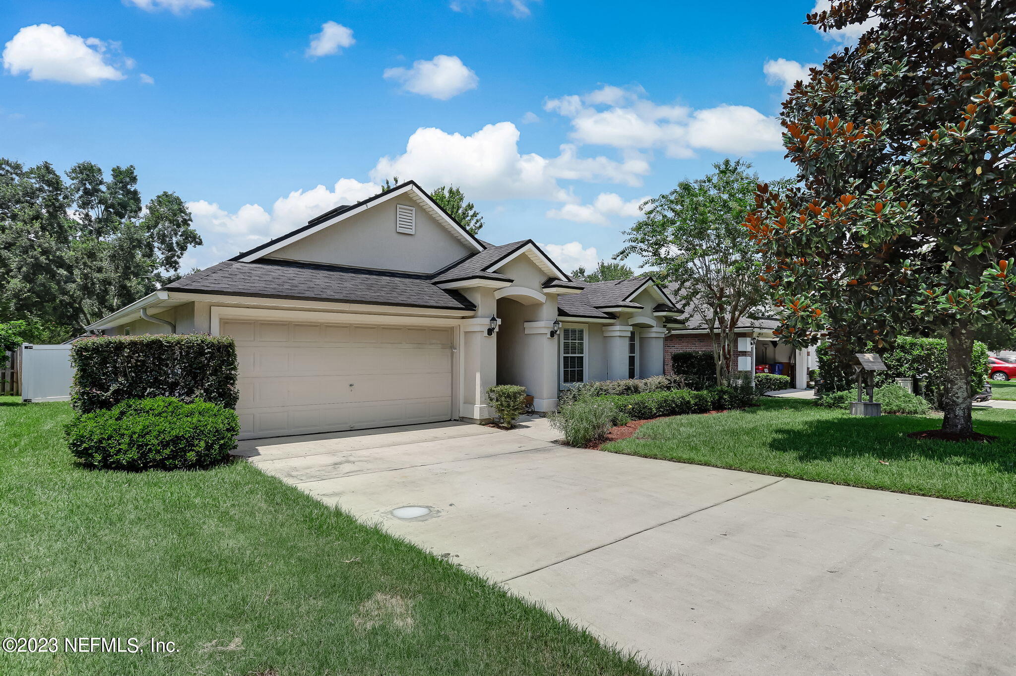 1564 Summerdown Way St. Johns, FL 32259 - Photo 2 of 83 a front view of a house with a garden and trees
