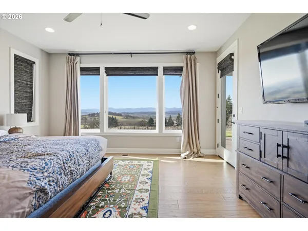 a living room with a bed furniture and next to a window