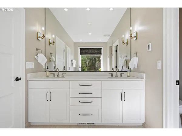 a bathroom with a sink vanity and a mirror