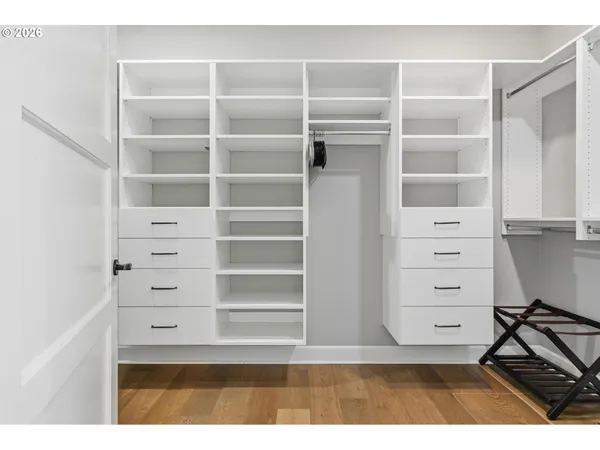 a view of walk in closet with empty racks