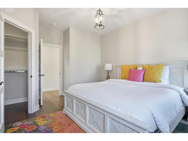 a bedroom with a bed and a painting on the wall
