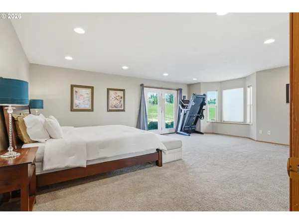 a bedroom with a bed and a television