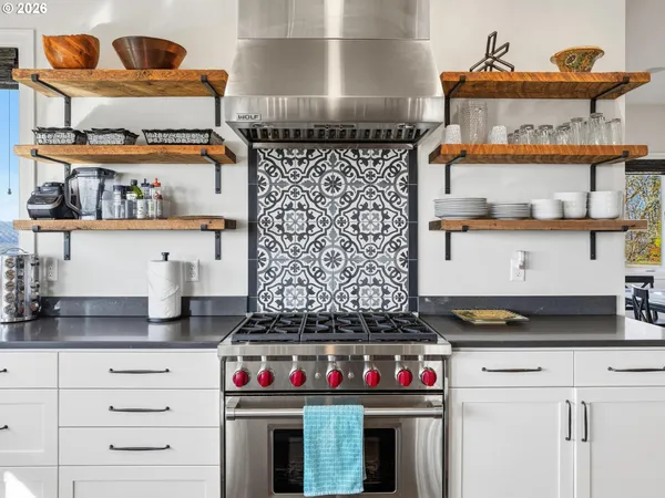 a kitchen with an oven a stove and cabinets