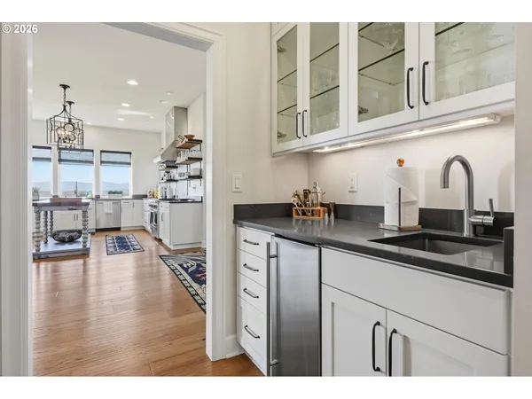 a kitchen with stainless steel appliances granite countertop a sink refrigerator and cabinets