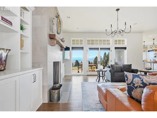 a living room with fireplace furniture and a chandelier