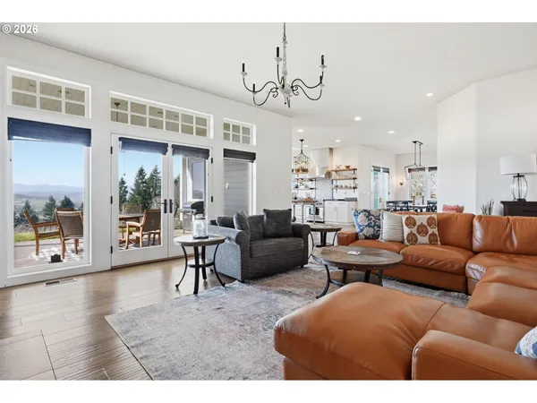 a living room with furniture a chandelier and a dining table