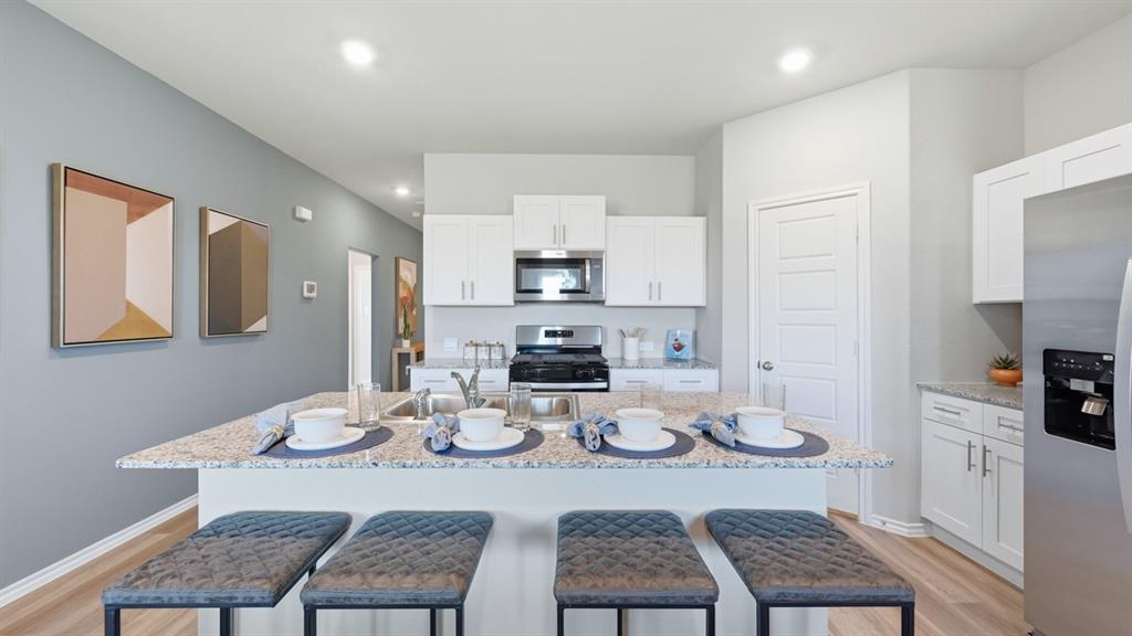 16500 Hudson Pr Way Justin, TX 76247 - Photo 36 of 38 a view of a dining room and kitchen with furniture wooden floor and a chandelier