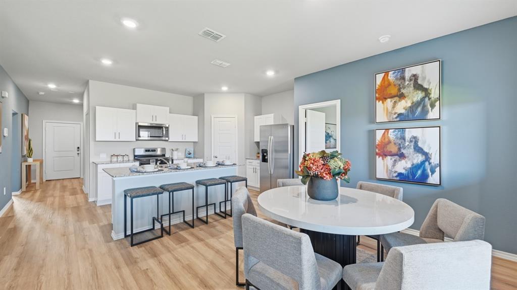 16500 Hudson Pr Way Justin, TX 76247 - Photo 7 of 38 a view of a dining room with furniture wooden floor and chandelier