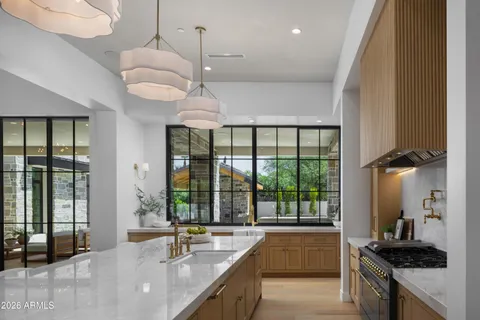 a large kitchen with a large window and stainless steel appliances