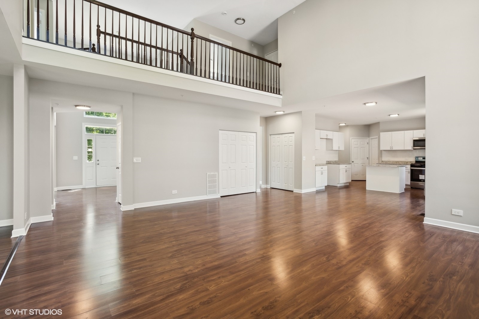 1489 Fox Path Lane Hoffman Estates, IL 60192 - Photo 11 of 27 a view of a hallway with wooden floor and a kitchen