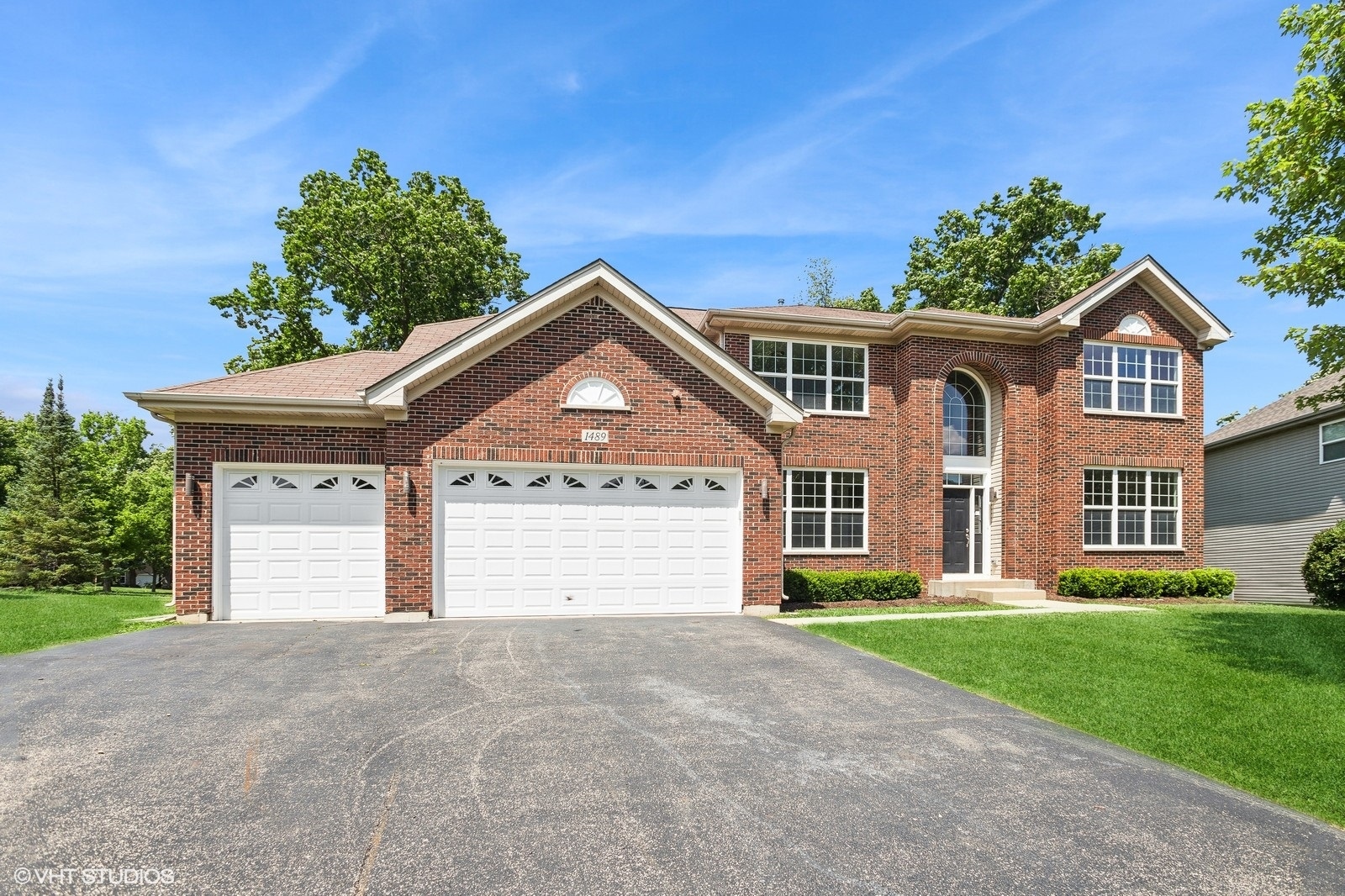 1489 Fox Path Lane Hoffman Estates, IL 60192 - Photo 2 of 27 a front view of a house with a yard and garage