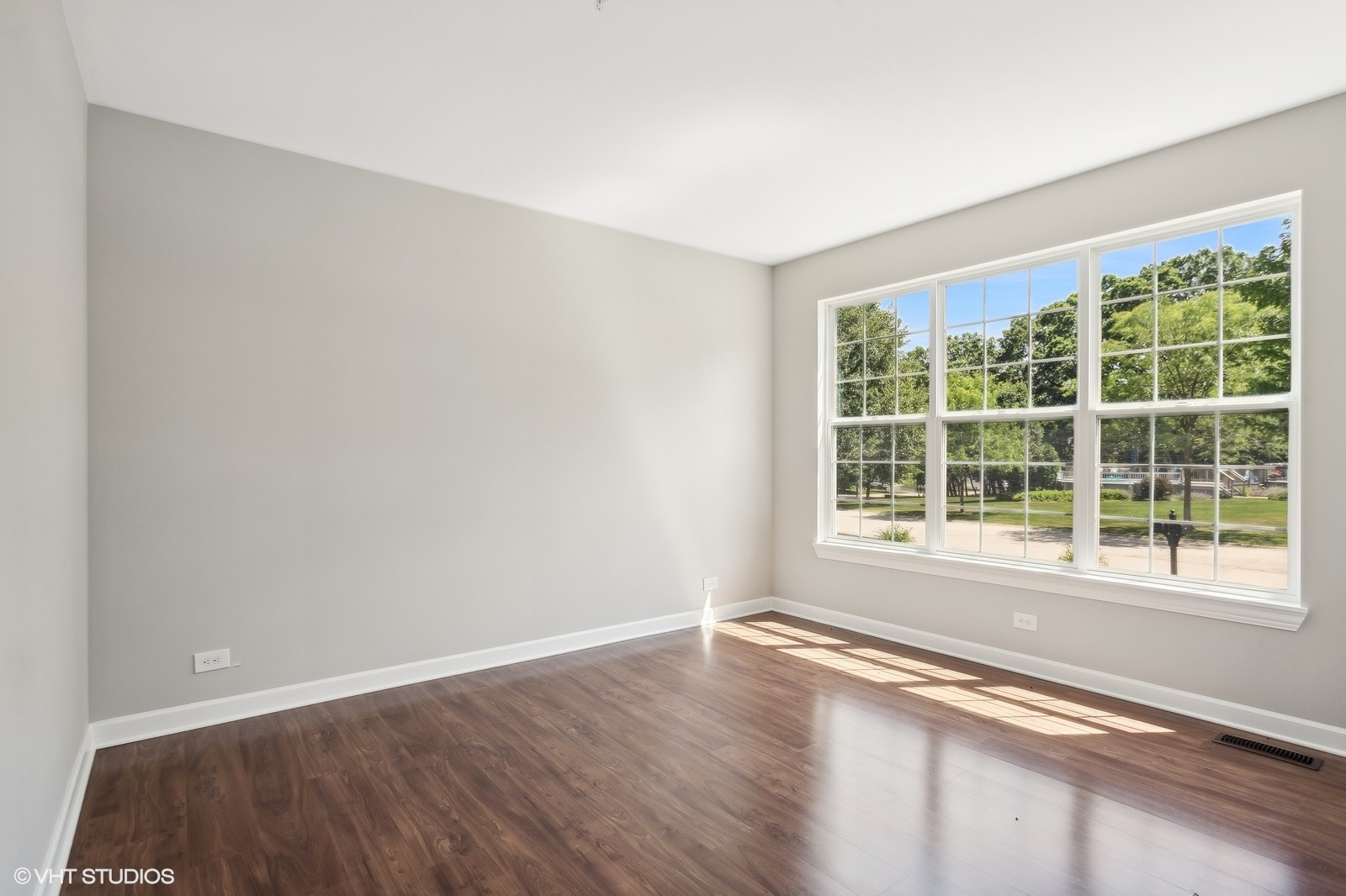 1489 Fox Path Lane Hoffman Estates, IL 60192 - Photo 4 of 27 a view of an empty room with a window and wooden floor