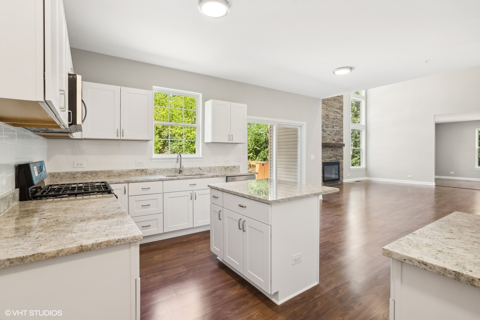 1489 Fox Path Lane Hoffman Estates, IL 60192 - Photo 6 of 27 a kitchen with granite countertop white cabinets and a wooden floor