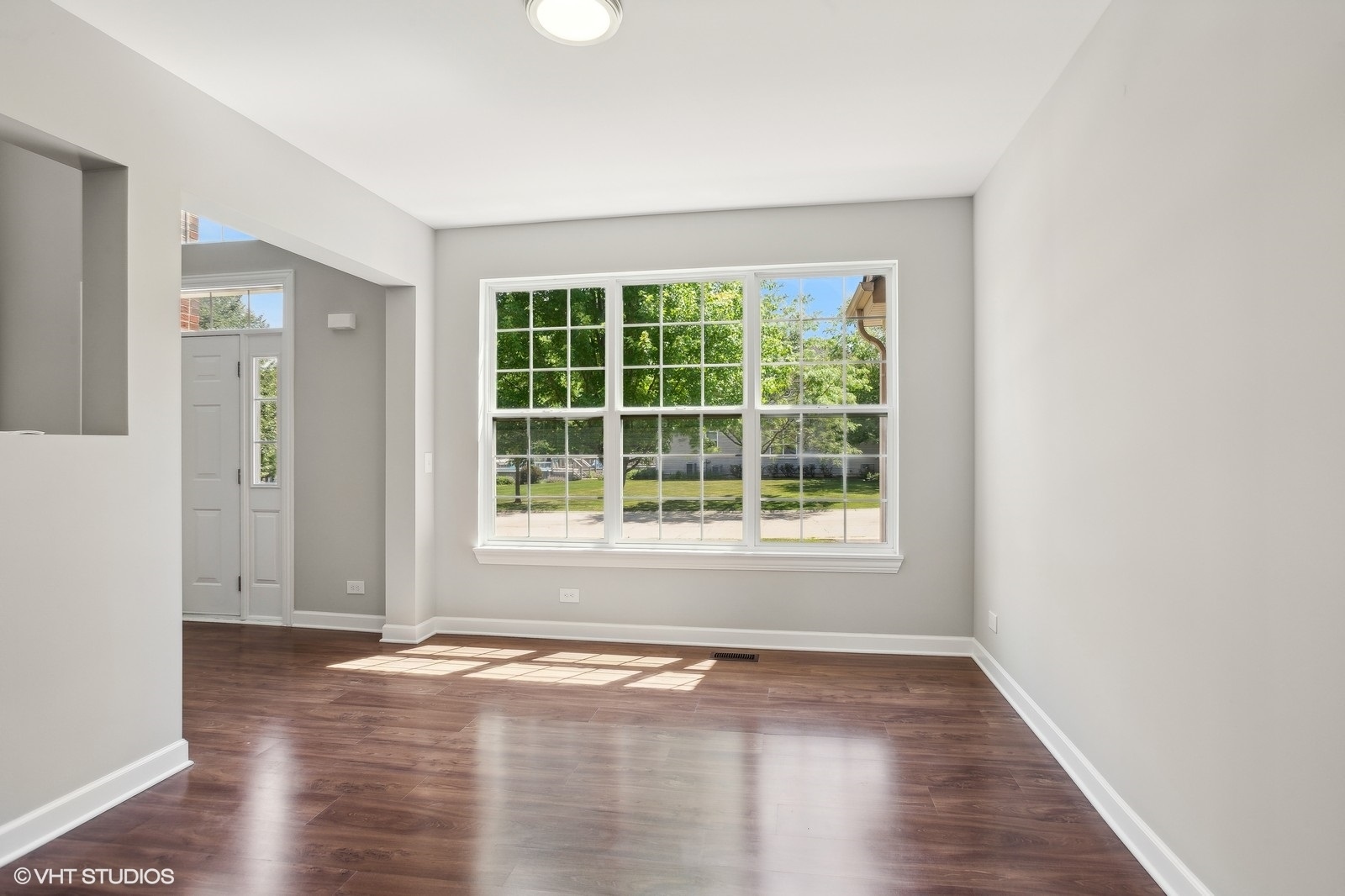 1489 Fox Path Lane Hoffman Estates, IL 60192 - Photo 8 of 27 an empty room with wooden floor and windows