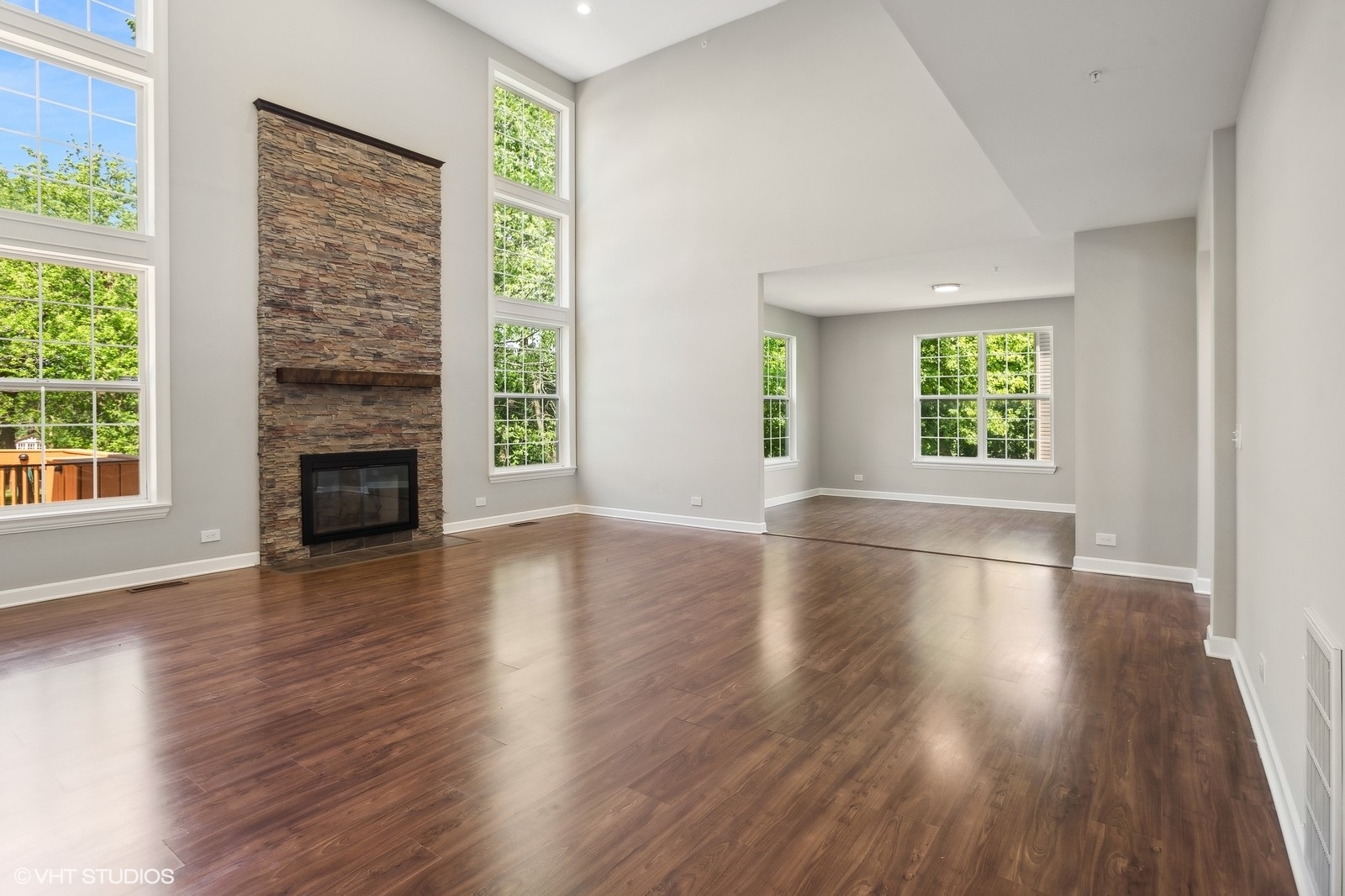 1489 Fox Path Lane Hoffman Estates, IL 60192 - Photo 9 of 27 an empty room with wooden floor windows and fireplace