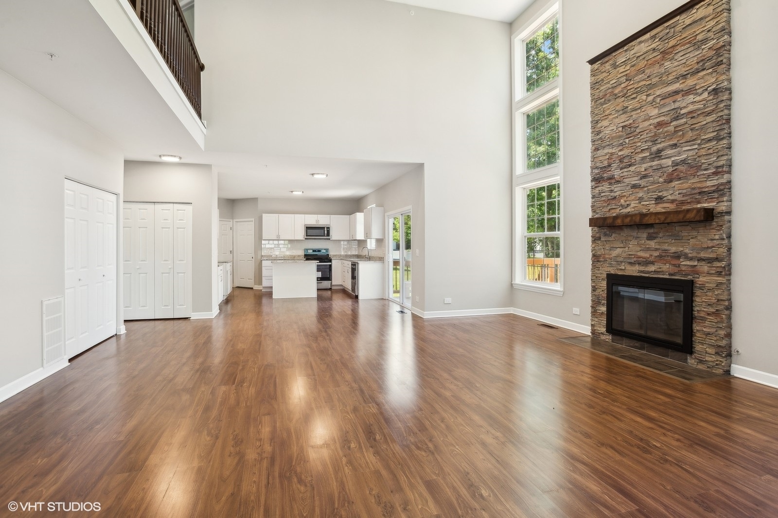1489 Fox Path Lane Hoffman Estates, IL 60192 - Photo 10 of 27 a view of empty room with wooden floor and fireplace