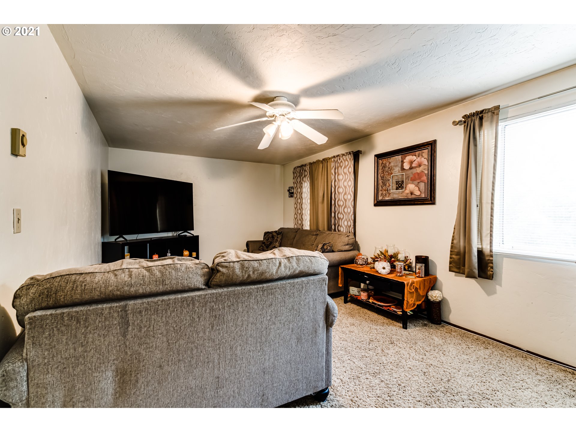 146 South 63rd Street Springfield, OR 97478 - Photo 8 of 27 a living room with furniture and a flat screen tv