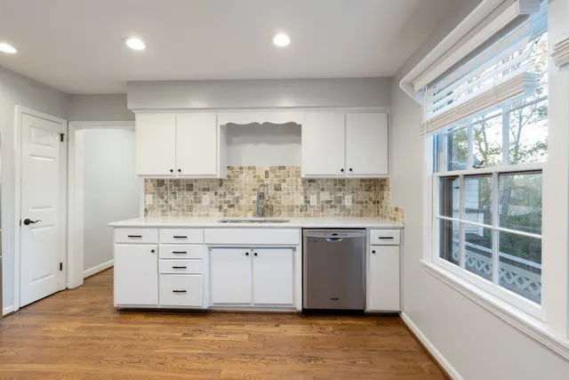 a stove top oven sitting inside of a kitchen