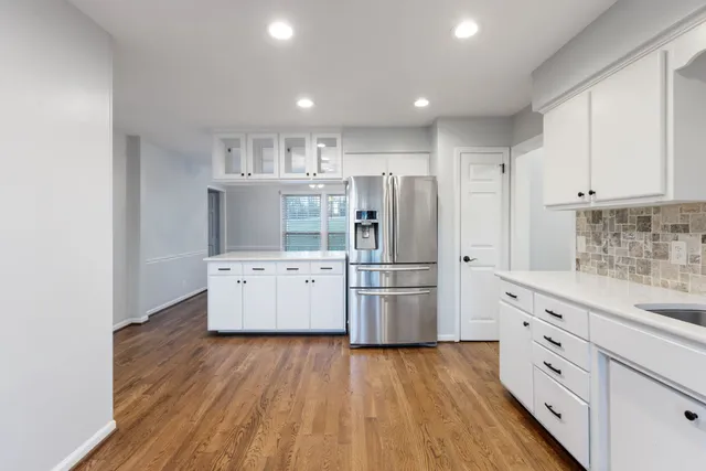 a kitchen with stainless steel appliances granite countertop a refrigerator and a stove