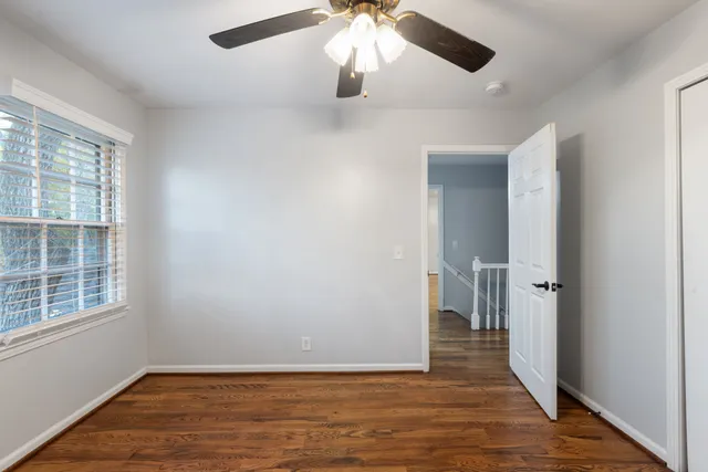 a view of house with a yard and large tree
