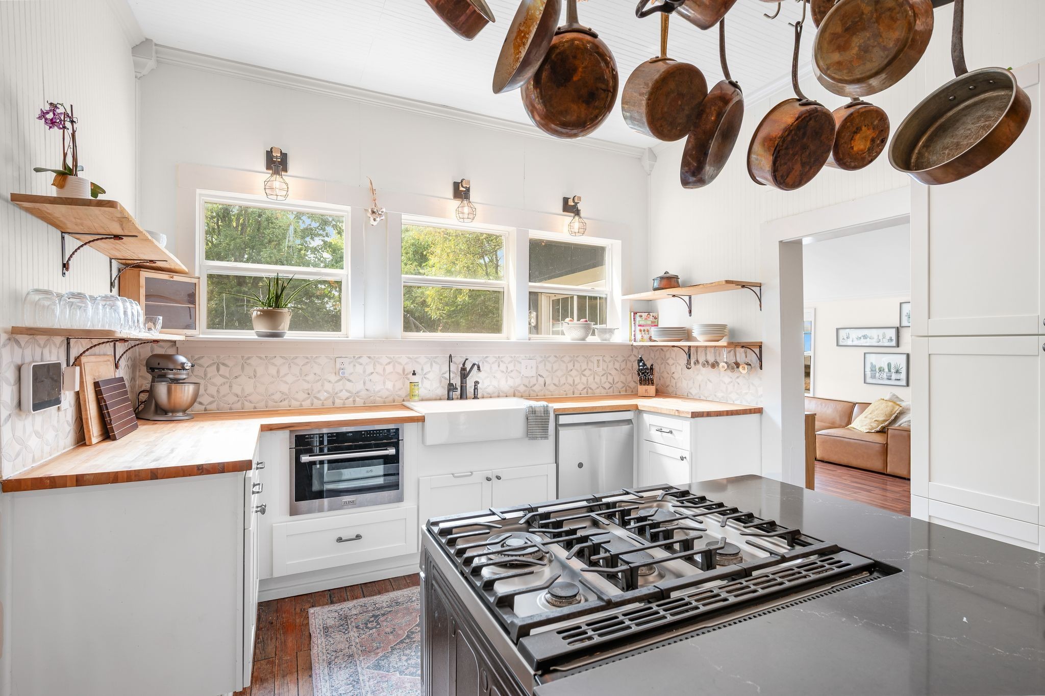a kitchen with a stove a sink and a window