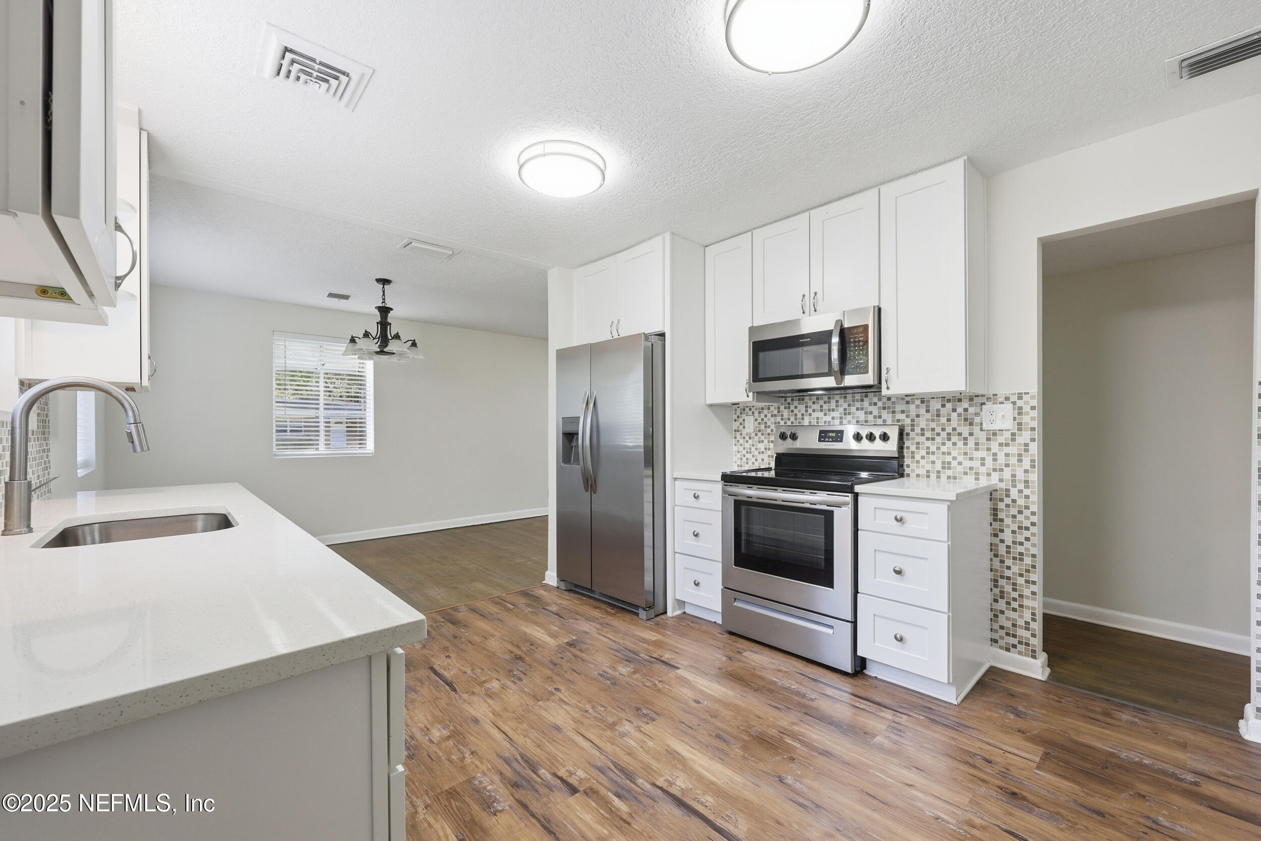 5201 Royce Avenue Jacksonville, FL 32205 - Photo 12 of 34 a kitchen with a sink cabinets and stainless steel appliances