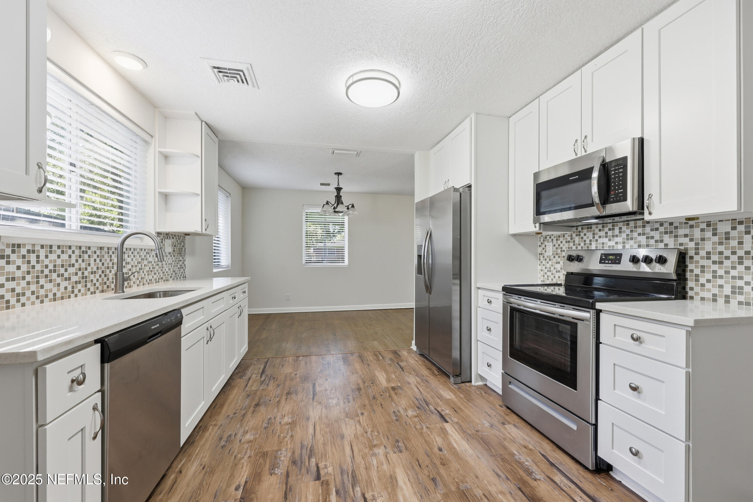 5201 Royce Avenue Jacksonville, FL 32205 - Photo 13 of 34 a kitchen with stainless steel appliances granite countertop a stove a sink and a refrigerator