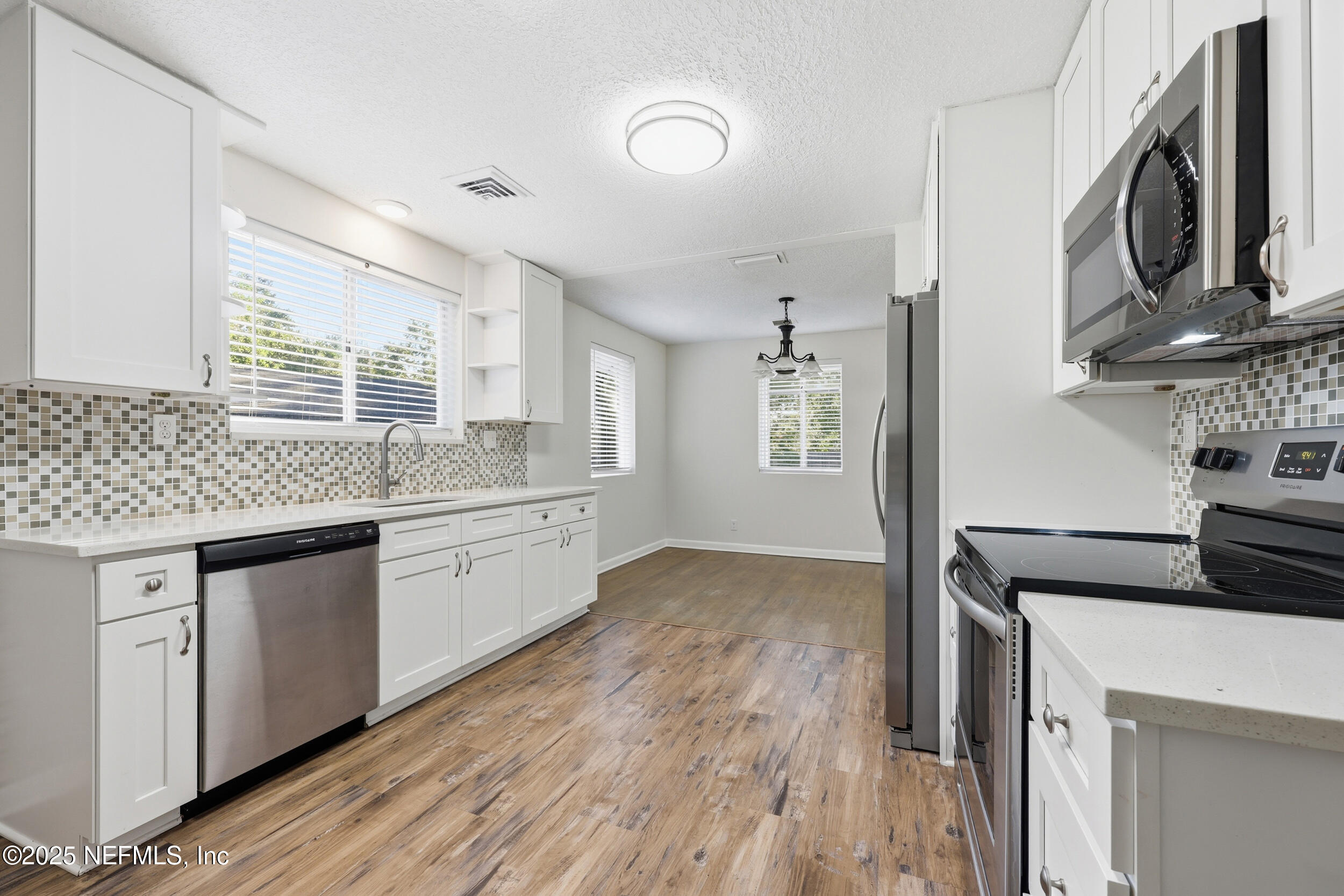 5201 Royce Avenue Jacksonville, FL 32205 - Photo 14 of 34 a kitchen with stainless steel appliances granite countertop a stove and cabinets