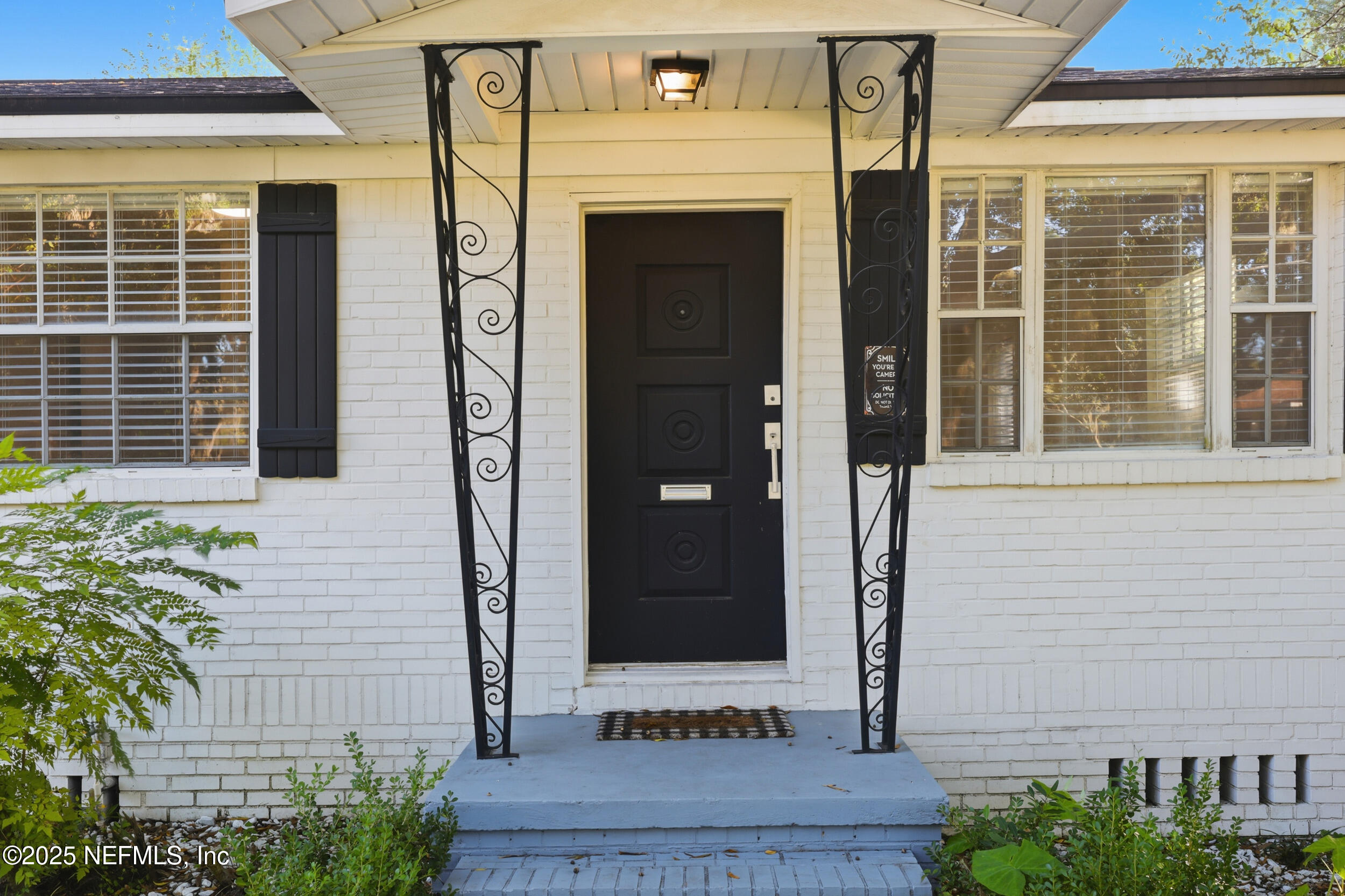 5201 Royce Avenue Jacksonville, FL 32205 - Photo 2 of 34 a front view of a house with a glass door and windows