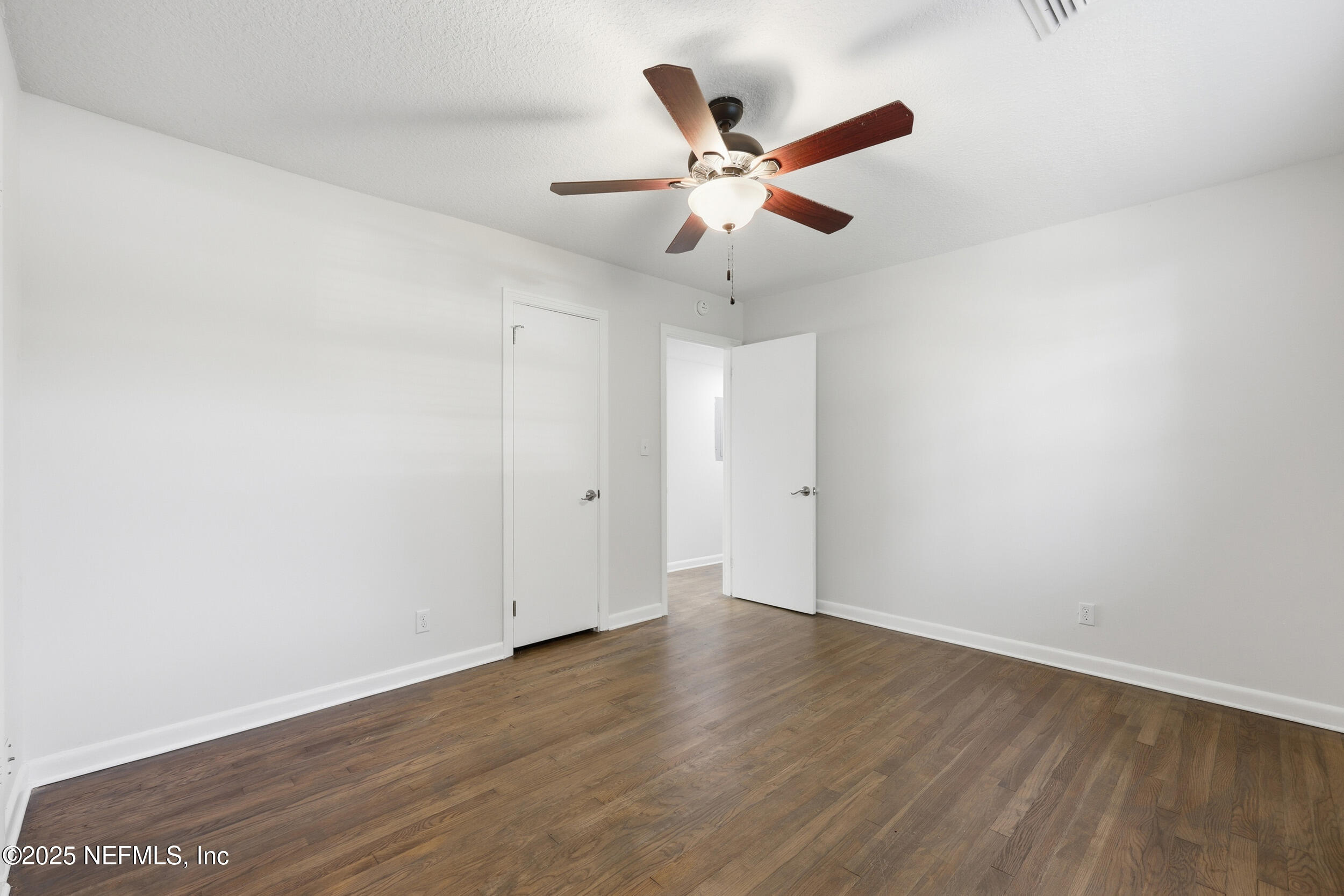 5201 Royce Avenue Jacksonville, FL 32205 - Photo 23 of 34 an empty room with wooden floor fan and windows