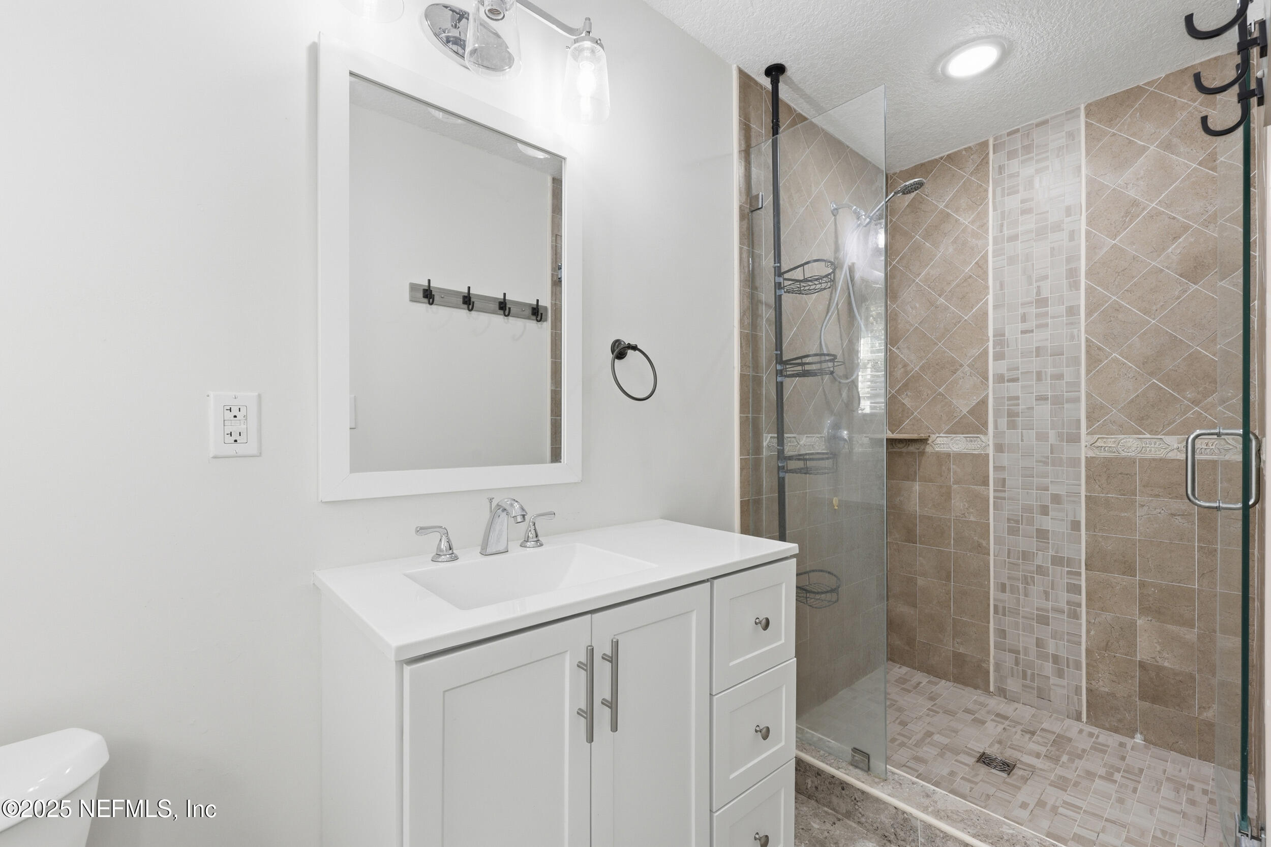 5201 Royce Avenue Jacksonville, FL 32205 - Photo 26 of 34 a bathroom with a shower sink and mirror