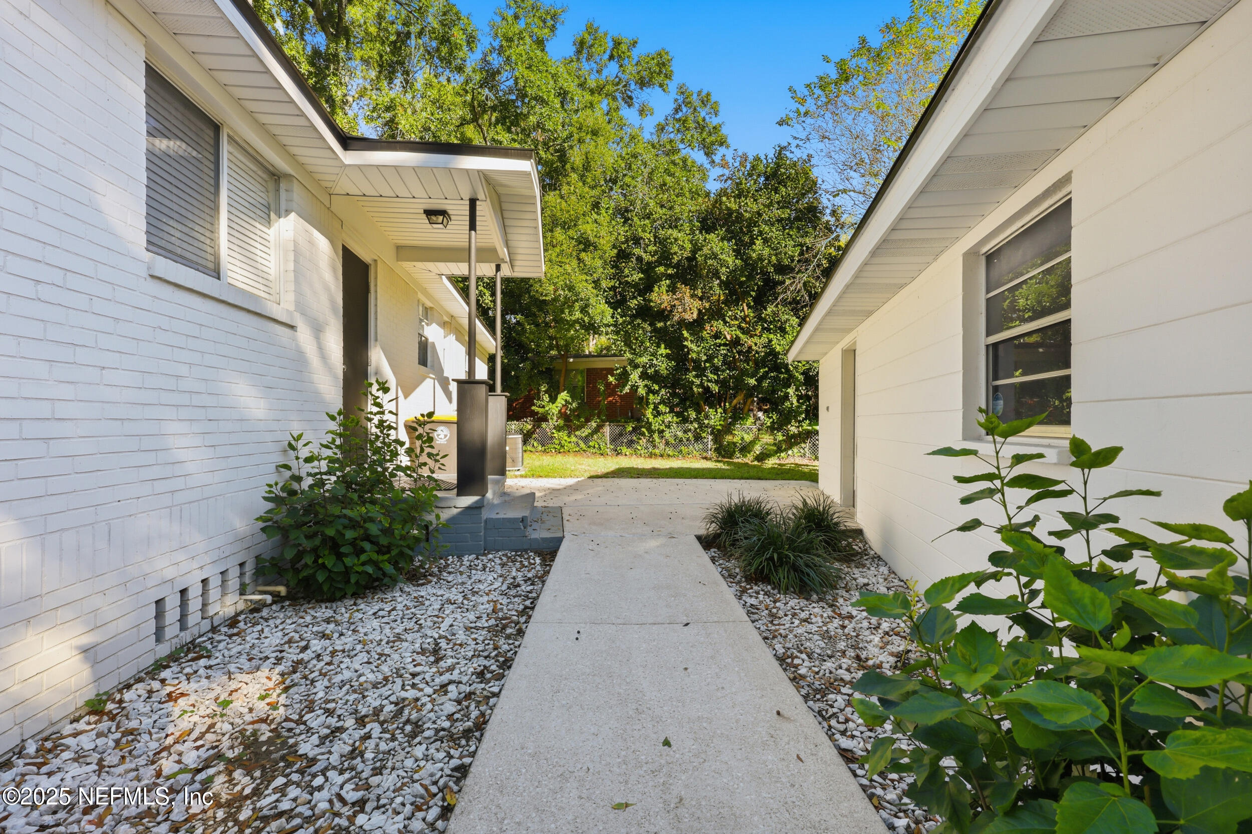 5201 Royce Avenue Jacksonville, FL 32205 - Photo 28 of 34 a pathway of a house with flower plants