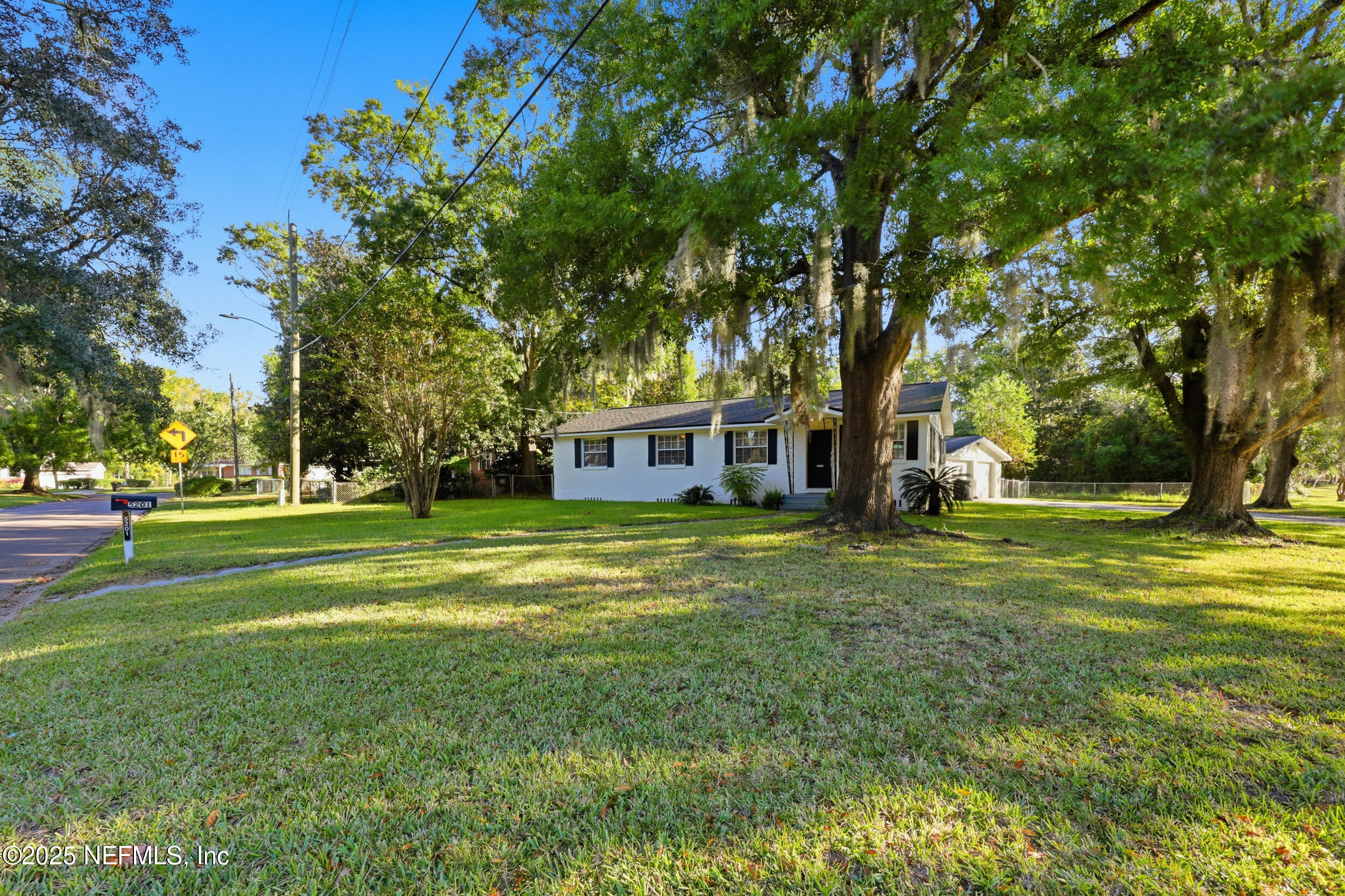 5201 Royce Avenue Jacksonville, FL 32205 - Photo 33 of 34 a view of a house next to a big yard with large trees