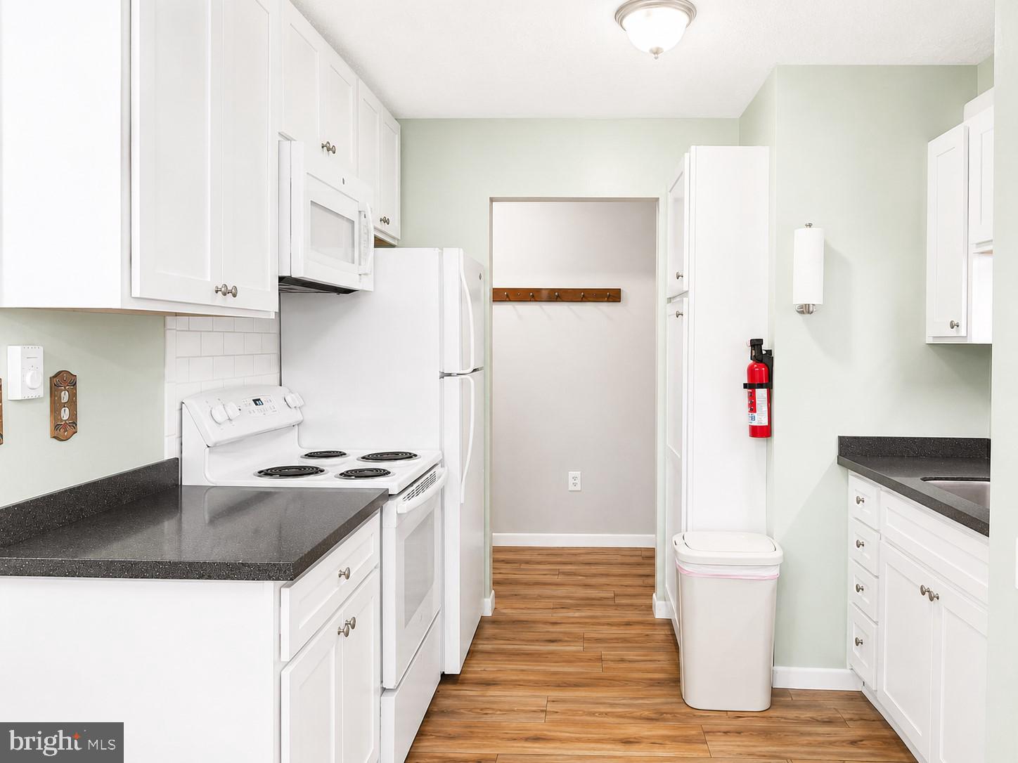 1724 Mosser Road, Unit 11 McHenry, MD 21541 - Photo 7 of 24 a kitchen with granite countertop a sink stove and refrigerator