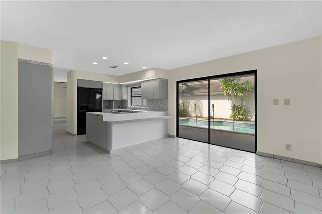 a large white kitchen with a stove top oven and cabinets