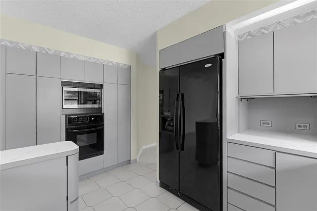 a kitchen with a refrigerator and a stove